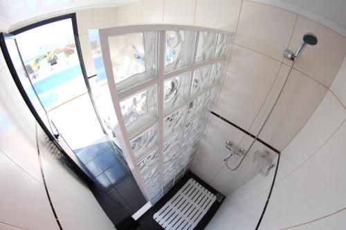 an overhead view of a bathroom with a shower at Casa da Rainha Bungallow in Estreito da Calheta