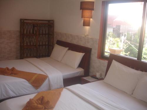 Кровать или кровати в номере Jasmine Family Hostel