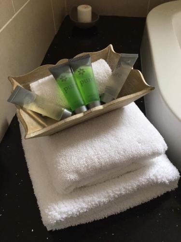 a pile of towels and toothbrushes sitting on a bathroom counter at St Kyrans Guest House in Virginia