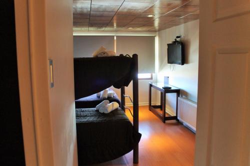 a bedroom with a bunk bed and a television at Hotel HF in Farellones