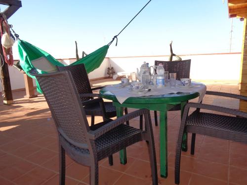 a table with chairs and an umbrella on a patio at Casa appartamento in Lampedusa