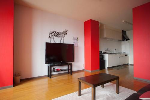 a living room with a television with a zebra on it at Riverside TABI-NE in Kanazawa
