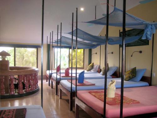 a room with a bunch of beds in it at The Magic Sponge in Kampot