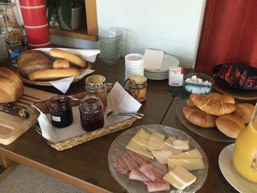 a table topped with plates of food and bread at Hotel Restaurant Koi-Gartenteich in Hausernmoos