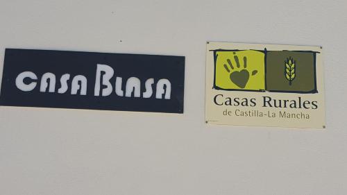 a sign for a casa blanca and a sign with a hand at Casa Rural CasaBlasa in Santo Domingo de Moya