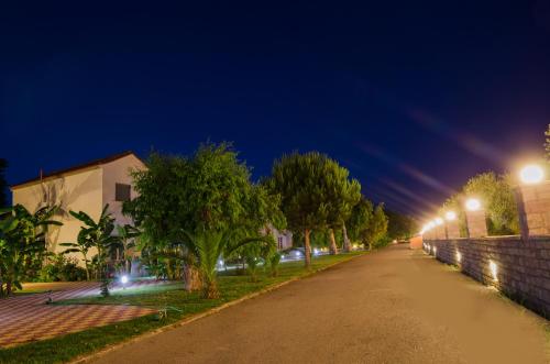 an empty street at night with street lights at Hotel Sias Resort in Agios Avgoustinos