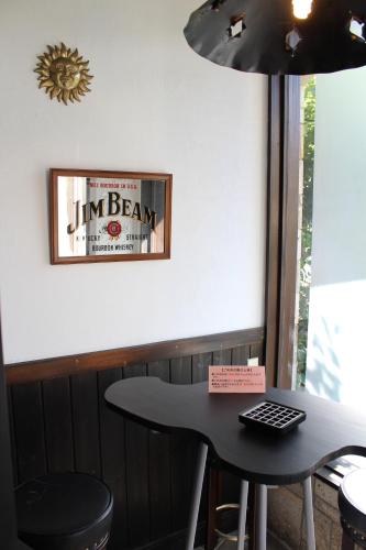 a table in a bar with a sign on the wall at Matsushima Petit Hotel Bistro Abalon in Matsushima