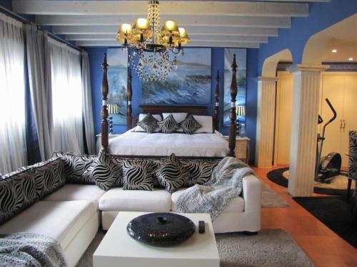 
a living room filled with furniture and a large window at Boutique Hotel Davallada- Adults Only in Sitges
