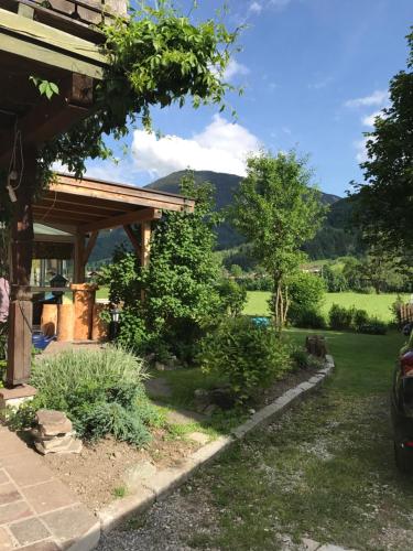 uitzicht vanuit de tuin van een huis met bergen op de achtergrond bij Pension Brixen im Thale in Brixen im Thale