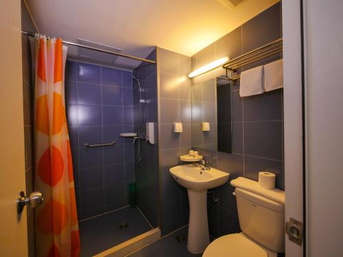 a bathroom with a toilet and a shower and a sink at Bestay Hotel Express Shenyang Imperial Palace Huaiyuanmen Subway Station in Shenyang