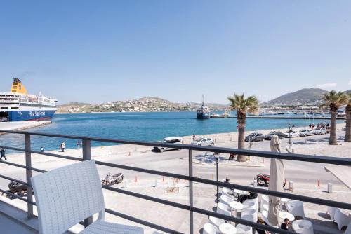 a balcony with a cruise ship in a harbor at Hotel Oasis in Parikia