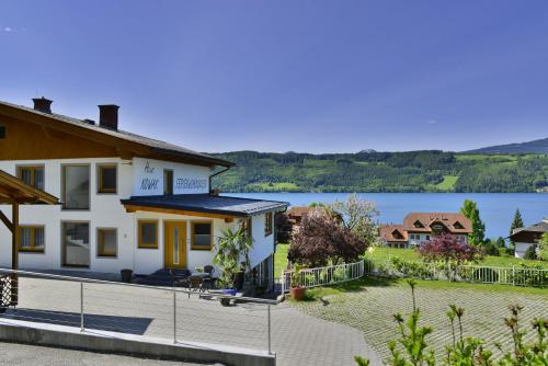 a house with a view of a lake at Haus Nowak Ferienwohnungen in Millstatt