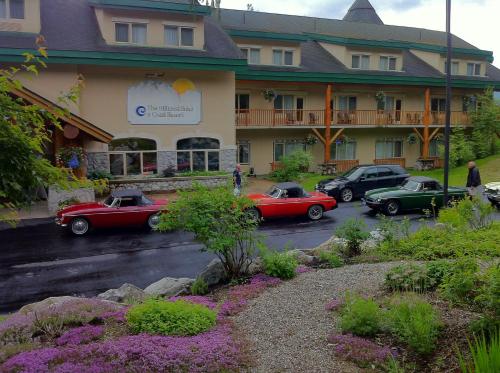 a group of cars parked in front of a hotel at Coast Hillcrest Hotel in Revelstoke