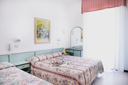 Postel nebo postele na pokoji v ubytování Hotel Villa Gori