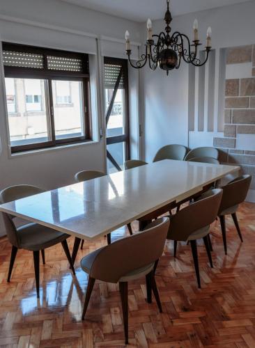 a dining room with a large table and chairs at Family Espinho Porto Guesthouse in Espinho