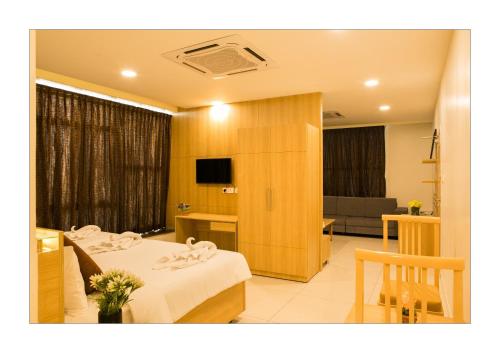 a hotel room with a bed and a couch at Hotel Ashoka in Rāmeswaram