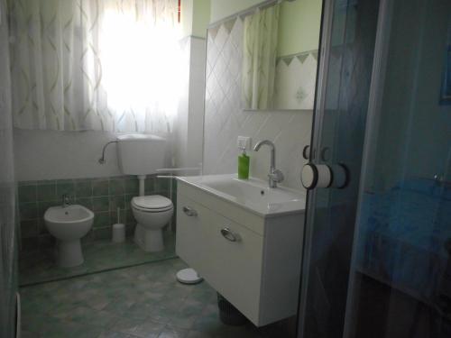 a bathroom with a sink and a toilet and a window at B&B Stella Marina in Soverato Marina