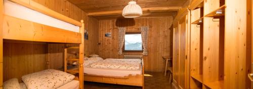 1 Schlafzimmer mit 2 Etagenbetten und einem Fenster in der Unterkunft Rifugio Fermeda Hutte in St. Christina in Gröden