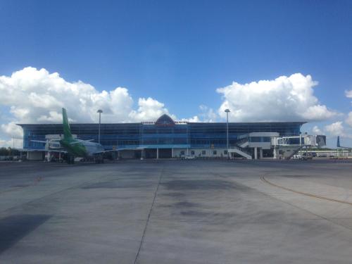 an airport with a plane parked in front of a building at Villa Tujuh in Senggigi 
