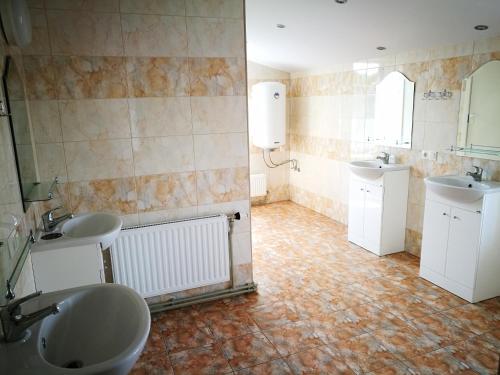 uma casa de banho com dois lavatórios e dois espelhos em Liela Guest Apartament em Liepāja