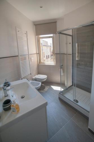 a bathroom with a shower and a sink and a toilet at Guest House Vignola in Rome