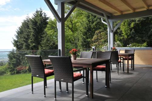 a group of tables and chairs on a patio at Zum Rebhang Bed & Breakfast in Oestrich-Winkel
