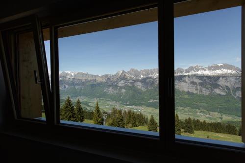 a window with a view of mountains at Berghotel Schonhalden in Flums