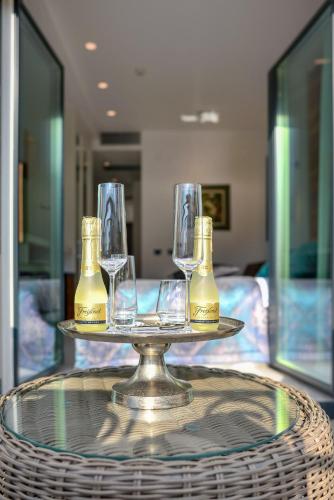 a tray with glasses and bottles on a table at Hotel Forza Terra in Kotor