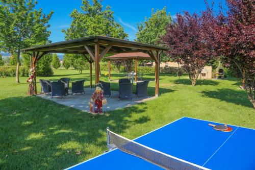 a ping pong table and a pavilion in a park at Agriturismo Il Brugnolo in Scandiano