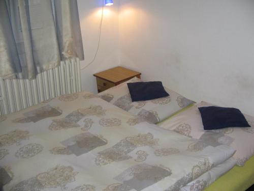 a bed with blue pillows on it in a bedroom at Penzion Zavodsky in Český Krumlov