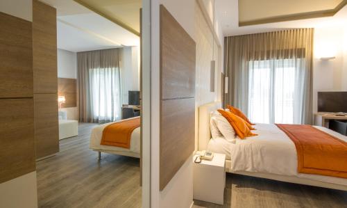 a hotel room with a bed and a bathroom at Hotel Aurora in Lido di Jesolo