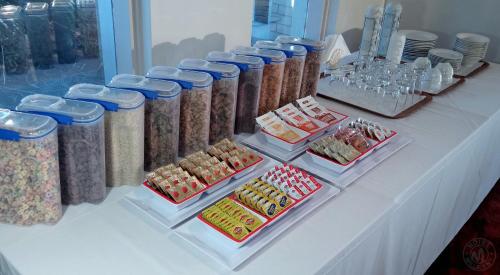 a table with many containers of food and other foods at Millicent Motel in Millicent