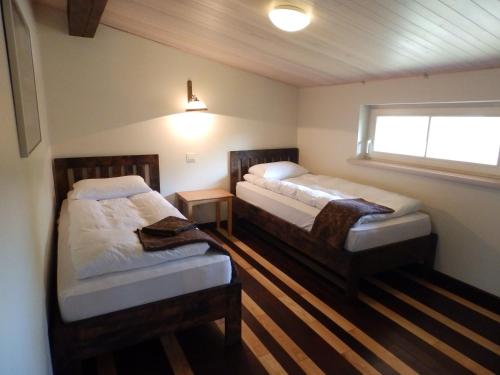 a bedroom with two beds and a window at Helsinkis in Anykščiai