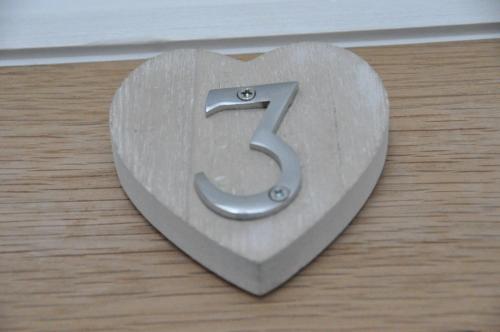 a heart shaped sign with the number five at Gordon House B & B in Tintagel