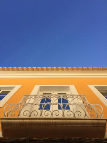 a balcony on the side of a building with a blue sky at NDS Prestige Guest House and Suites - NDS Hotels in Portimão