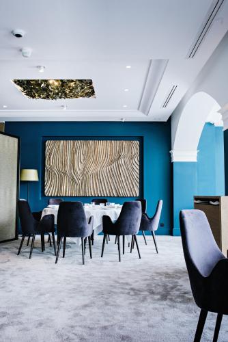 a conference room with a table and chairs at Auberge Du Père Bise - Jean Sulpice in Talloires