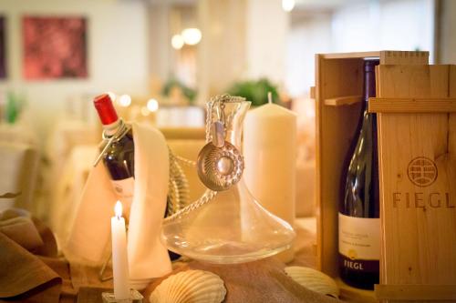 a table with a bottle of wine and a candle at Hotel Garden Sea Wellness & Spa 4 stelle superior in Caorle