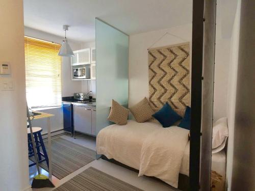a bedroom with a bed with a large mirror at L'Hotel Particulier Griffintown in Montréal