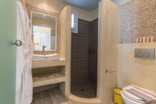 a bathroom with a shower and a toilet and a sink at Michaella Studios in Plaka