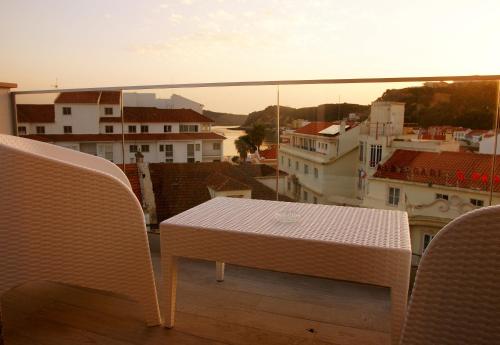 a table and chairs on a balcony with a view at Hotel Concha in São Martinho do Porto
