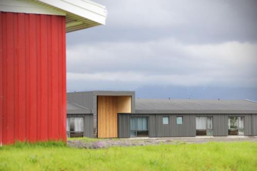 a group of buildings with a red building at Lilja Guesthouse in Höfn