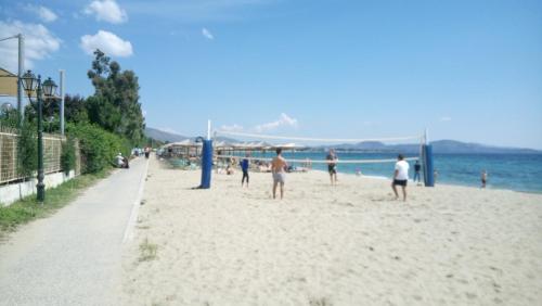 a group of people playing soccer on the beach at Villa George - Family Holidays in Nea Makri