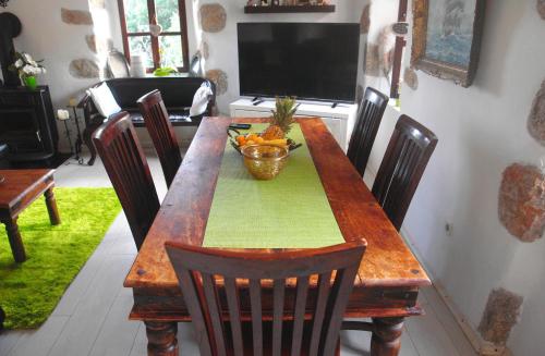 a wooden table with a bowl of fruit on it at Apartment La-Vi in Stara Baška