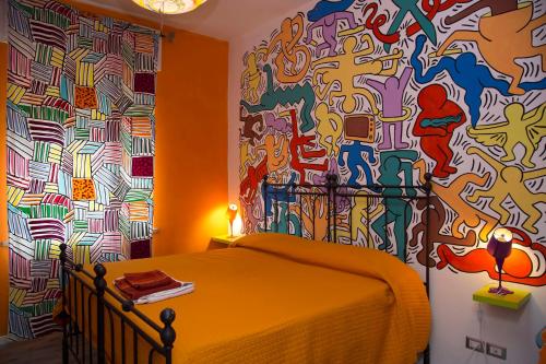 a bedroom with a wall covered in graffiti at I Tre Arcangeli LT in Verona