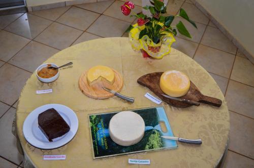 a table topped with plates of food on top at Hotel Chapadao Da Canastra in São Roque de Minas