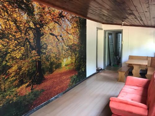 a living room with a wall mural of a forest at The White House by Casona Lo Aguirre - El Monte RM in Talagante
