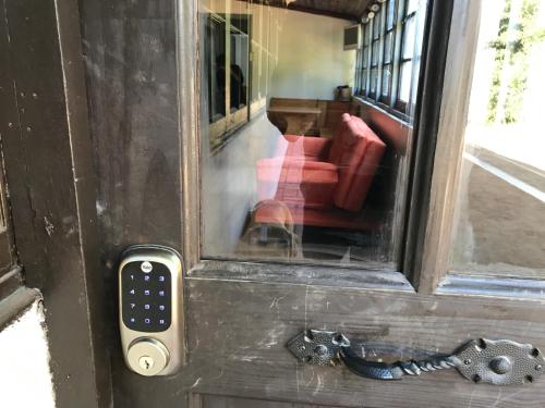 an open door with a remote control on it at The White House by Casona Lo Aguirre - El Monte RM in Talagante