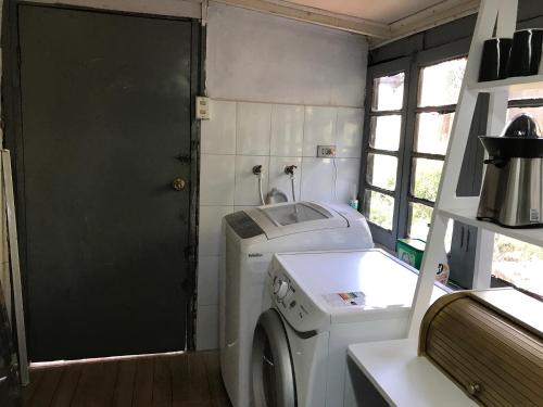 a laundry room with a washing machine and a sink at The White House by Casona Lo Aguirre - El Monte RM in Talagante