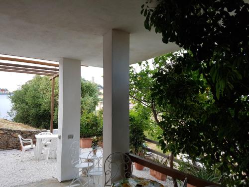 a view from the outside of a house with a tree at Su Sole in Posada
