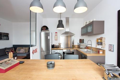 - une grande cuisine avec une table en bois dans l'établissement Budin Sea Cannes, à Cannes